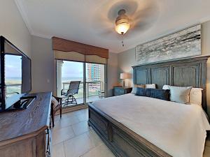 a bedroom with a large bed and a large window at Portofino Island Resort #1-702 in Pensacola Beach +20 photos