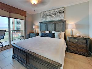 a bedroom with a large bed and a large window at Portofino Island Resort #1-702 in Pensacola Beach