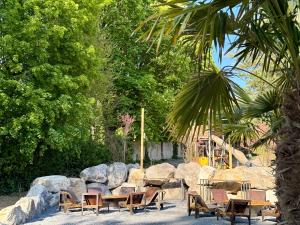 a group of tables and chairs in a park at Évasion famille - Dune Blanche in Camiers