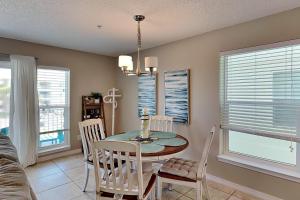 a dining room with a table and chairs at Gulf Island #621 in Navarre