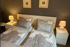 a bedroom with two beds and two night stands at Ferienwohnung 2 Gemutlich & komfortabel im Erdgeschoss in Borkum