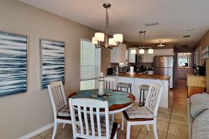 a kitchen and dining room with a table and chairs at Gulf Island #621 in Navarre
