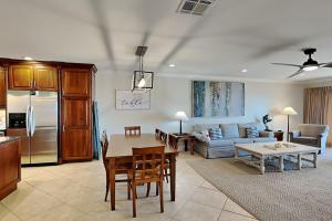 a kitchen and living room with a table and a couch at Aegean #332 in Destin