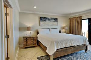a bedroom with a large bed and a window at Aegean #332 in Destin +18 photos