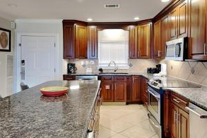 a kitchen with wooden cabinets and a bowl on a counter at Aegean #332 in Destin