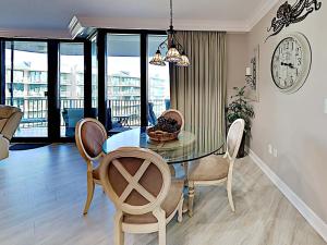a dining room with a glass table and chairs at Phoenix on the Bay #1410 in Orange Beach +18 photos