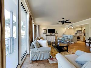 a living room with a couch and a dining room at Gulf Place Six Palms #2B - BBs Hideaway in Santa Rosa Beach