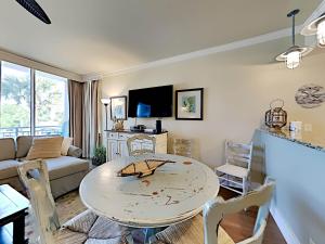 a living room with a table and a couch at Gulf Place Six Palms #2B - BBs Hideaway in Santa Rosa Beach