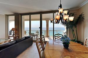 a dining room with a table with a view of the ocean at Beach Club #1804C in Pensacola Beach