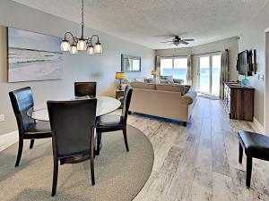 a living room with a table and a couch at Emerald Isle #405 in Pensacola Beach