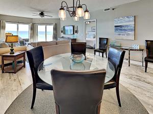 a dining room and living room with a table and chairs at Emerald Isle #405 in Pensacola Beach +20 photos