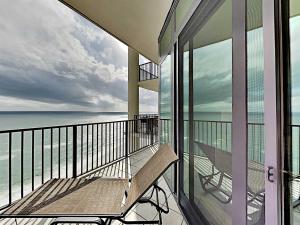 a balcony with a bench and the ocean on it at Phoenix West II #2109 in Orange Beach