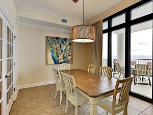 a dining room with a table and chairs at Phoenix West II #2109 in Orange Beach
