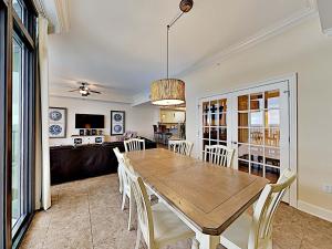 a dining room with a wooden table and chairs at Phoenix West II #2109 in Orange Beach