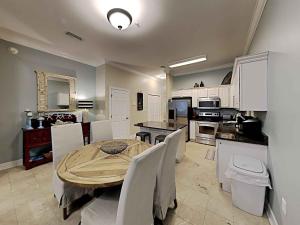 a kitchen and dining room with a table and chairs at Seagrove Highlands #2104 in Santa Rosa Beach