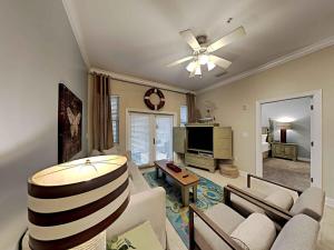 a living room with a couch and a ceiling fan at Seagrove Highlands #2104 in Santa Rosa Beach