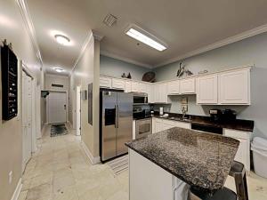 a kitchen with white cabinets and stainless steel appliances at Seagrove Highlands #2104 in Santa Rosa Beach