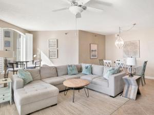 a living room with a couch and a table at Beach Colony Towers #15C in Perdido Key