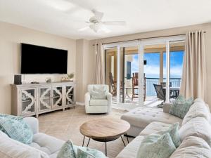 a living room with a couch and a tv at Beach Colony Towers #15C in Perdido Key