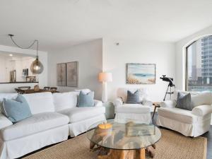 a living room with a white couch and a table at Beach Colony Towers #2B - Villa Monarch in Perdido Key