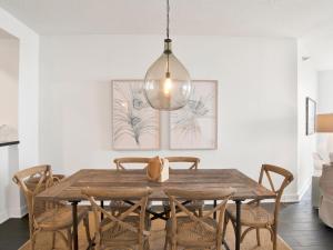 a dining room with a wooden table and chairs at Beach Colony Towers #2B - Villa Monarch in Perdido Key +27 photos