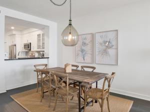 a dining room with a wooden table and chairs at Beach Colony Towers #2B - Villa Monarch in Perdido Key
