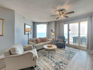 a living room with a couch and a table at Beach Colony West #PH3B 18B in Perdido Key