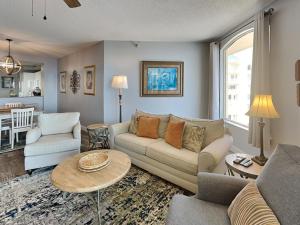 a living room with a couch and a table at Beach Colony West #PH3B 18B in Perdido Key