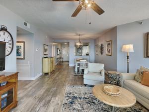 a living room with a couch and a table at Beach Colony West #PH3B 18B in Perdido Key