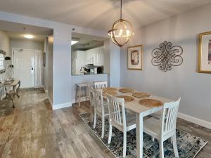 a kitchen and dining room with a table and chairs at Beach Colony West #PH3B 18B in Perdido Key +32 photos