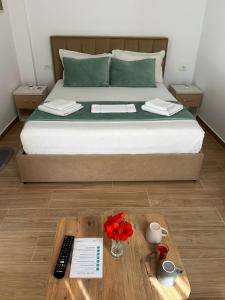 a bedroom with a bed with a tray with flowers on it at Lexhulo Room's in Domje