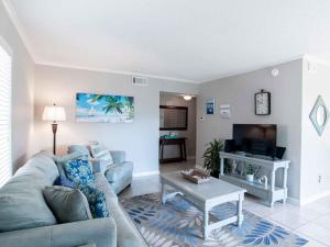 a living room with a couch and a table at Villas on the Gulf #E7 - Flip Flop Inn in Pensacola Beach