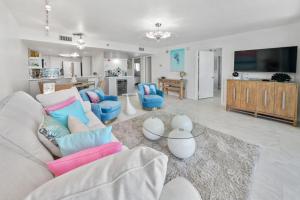 a living room with a white couch and blue chairs at One Seagrove Place #1308 - "Love at First Sight" in Santa Rosa Beach