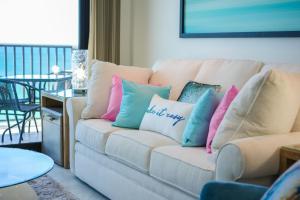a living room with a couch with pillows on it at One Seagrove Place #1308 - "Love at First Sight" in Santa Rosa Beach