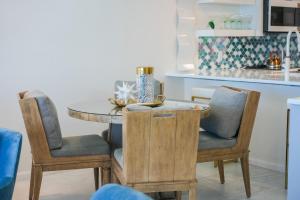 a dining room table with two chairs and a table at One Seagrove Place #1308 - "Love at First Sight" in Santa Rosa Beach +26 photos