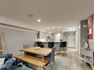 a dining room and kitchen with a table and chairs at Aegean 327 in Destin