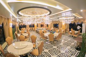 a banquet hall with tables and chairs and chandeliers at Gallant Hotel 168 in Hai Phong