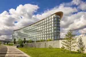 a large office building with a curved roof at Hilton Astana in Astana
