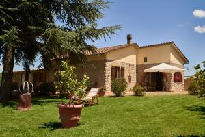 a house with a tree in front of a yard at Tenuta il Poggetto in Radda in Chianti