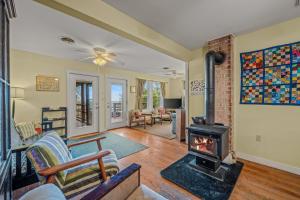 a living room with a wood stove in it at Above Sleepy Hollow - Rooftop Deck, Amazing Views, Hot Tub, Pet Friendly, Screen Porch, Wifi, EV Station, Games, Trails, Wood Stove, Charcoal Grill, Lake Access, King Bed in Hedgesville