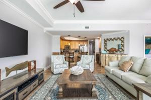 a living room with a couch and a table at The Oasis at Orange Beach 1707 in Orange Beach