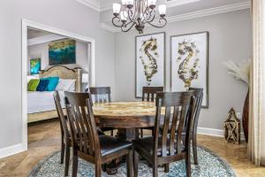 a dining room with a table and chairs and a bed at The Oasis at Orange Beach 1707 in Orange Beach