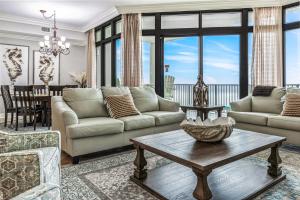a living room with a couch and a table at The Oasis at Orange Beach 1707 in Orange Beach