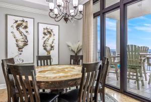 a dining room with a table and chairs and a window at The Oasis at Orange Beach 1707 in Orange Beach