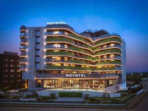 a novation hotel is lit up at night at Novotel Goa Panjim in Panaji