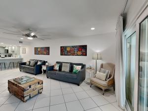 a living room with couches and chairs and a table at Tiki Tango Hideaway in Panama City Beach
