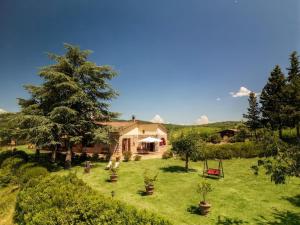 a house with a yard with trees and a playground at Tenuta il Poggetto in Radda in Chianti +45 photos