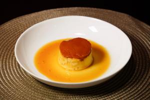 a dessert in a white bowl on a table at Oásis Motel Piracicaba in Piracicaba +45 photos