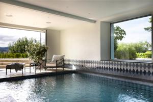 a swimming pool in a house with a window at Château Marnand - Studio Montgolfières in Granges