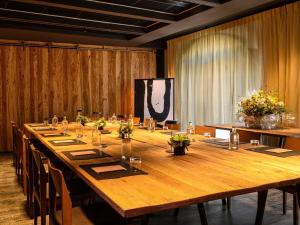 a large wooden table in a conference room with chairs at L'Isle de Leos Hotel & Spa - MGallery Collection in L'Isle-sur-la-Sorgue +187 photos